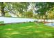 Expansive backyard with lush green lawn, pool, and swing set for leisure at 142 Wilson Ne St, Concord, NC 28025