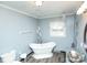 Bright bathroom showcases a freestanding tub, unique vanity, and elegant fixtures at 142 Wilson Ne St, Concord, NC 28025