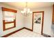 Cozy dining room featuring tile flooring, a chandelier, and a vintage glass paneled door at 142 Wilson Ne St, Concord, NC 28025