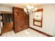 Open dining room with tile flooring, chandelier lighting, and a brick feature wall with built-in cabinets at 142 Wilson Ne St, Concord, NC 28025