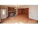 Spacious living room with a brick fireplace, hardwood floors, and a view into an adjacent room at 142 Wilson Ne St, Concord, NC 28025