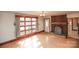 Bright living room featuring a brick fireplace, hardwood floors, and a large window at 142 Wilson Ne St, Concord, NC 28025