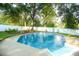 Beautiful in-ground pool and landscaped yard surrounded by mature trees at 142 Wilson Ne St, Concord, NC 28025