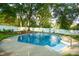 In-ground pool surrounded by lush landscaping and a white privacy fence at 142 Wilson Ne St, Concord, NC 28025