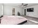 Spacious bedroom with a TV, ceiling fan, carpet floor, and an adjoining bathroom at 146 Dogwood Grove Pl, Troutman, NC 28166