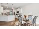 Kitchen and dining area with stainless steel appliances, white cabinets, and hardwood floors at 146 Dogwood Grove Pl, Troutman, NC 28166