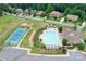 Overhead view of neighborhood with pool, tennis court, playground, and lush greenery, a perfect spot for families at 147 Belfry Loop, Mooresville, NC 28117