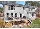 Rear exterior view of the house featuring a deck with dining furniture and a covered patio at 147 Belfry Loop, Mooresville, NC 28117
