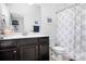 Well-appointed bathroom with a dark wood vanity, white countertops, and a shower-tub combination, offering both style and function at 147 Belfry Loop, Mooresville, NC 28117