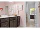 Bathroom features a dark vanity with double sinks and a view into an adjoining room at 147 Belfry Loop, Mooresville, NC 28117