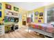 Bright yellow bedroom featuring a bed, desk, and art supplies, great for creative pursuits at 147 Belfry Loop, Mooresville, NC 28117