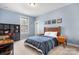 Cozy bedroom with wood furniture, blue bedding, and natural light from the window at 147 Belfry Loop, Mooresville, NC 28117