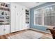 Stylish bedroom featuring a Murphy bed, built-in bookshelves, and ample natural light, perfect for a home office or guest suite at 147 Belfry Loop, Mooresville, NC 28117