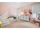 Charming pink bedroom featuring a bed with canopy, a dresser, and window at 147 Belfry Loop, Mooresville, NC 28117