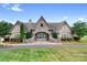 Well-maintained clubhouse showcasing an inviting stone facade, manicured lawn, and decorative flags at 147 Belfry Loop, Mooresville, NC 28117