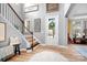 Bright foyer with hardwood floors, staircase, and views into adjoining rooms at 147 Belfry Loop, Mooresville, NC 28117