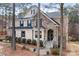 Beautiful home featuring a stone and brick facade with a covered front entrance and manicured shrubs at 147 Belfry Loop, Mooresville, NC 28117