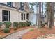 Charming brick home with a stone entrance, complimented by a neatly landscaped walkway and lush greenery at 147 Belfry Loop, Mooresville, NC 28117