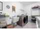 Well-organized laundry room with modern washer and dryer, utility sink, and ample shelving at 147 Belfry Loop, Mooresville, NC 28117