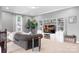 Inviting living room featuring a cozy sofa, built-in shelving, and natural light, creating a comfortable and stylish entertaining space at 147 Belfry Loop, Mooresville, NC 28117