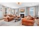 Cozy living room with a fireplace and comfortable leather sofas at 147 Belfry Loop, Mooresville, NC 28117