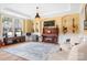 Bright, stylish living room featuring a piano and hardwood floors at 147 Belfry Loop, Mooresville, NC 28117