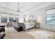 Spacious main bedroom suite with a sitting area, plenty of natural light, and elegant décor for a relaxing retreat at 147 Belfry Loop, Mooresville, NC 28117