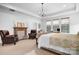 Luxurious main bedroom suite with a fireplace, sitting area, and abundant natural light, creating a serene and elegant atmosphere at 147 Belfry Loop, Mooresville, NC 28117