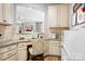Dedicated home office nook with custom cabinets, granite countertops, and an inviting chair, ideal for productivity and organization at 147 Belfry Loop, Mooresville, NC 28117