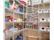 Organized walk-in pantry with white wire shelving and labeled storage containers for optimal kitchen storage and convenience at 147 Belfry Loop, Mooresville, NC 28117