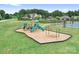 Well-equipped community playground with slides, swings, and play structures set on a grassy lawn at 147 Belfry Loop, Mooresville, NC 28117