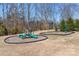 A spacious neighborhood playground offering a variety of slides and swings on grassy lawn with wooded backdrop at 147 Belfry Loop, Mooresville, NC 28117