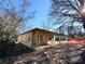 Exterior of house during renovations with covered porch with ample yard space and bright blue skies at 1600 Julia Maulden Pl, Charlotte, NC 28206