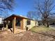 Exterior of house during renovations with wood supports and covered porch with ample yard space at 1600 Julia Maulden Pl, Charlotte, NC 28206