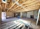 Renovation of an interior, showing exposed wooden beams, and the beginning stages of construction at 1600 Julia Maulden Pl, Charlotte, NC 28206