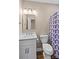 This bathroom includes a shower with a geometric curtain and marble countertop vanity at 163 Singleton Rd, Mooresville, NC 28117