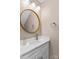 Contemporary half bath features a round mirror, modern lighting, and stylish fixtures at 163 Singleton Rd, Mooresville, NC 28117