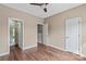 A bright bedroom offers an en suite bathroom and a closet, with modern hardwood floors at 163 Singleton Rd, Mooresville, NC 28117