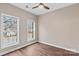 An empty bedroom showcases wood floors and natural light from the double windows at 163 Singleton Rd, Mooresville, NC 28117