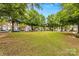 Common area of manicured lawn framed by mature shade trees and brick townhomes at 163 Singleton Rd, Mooresville, NC 28117