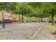 Community common area includes a gravel playing area bordered by mature shade trees at 163 Singleton Rd, Mooresville, NC 28117
