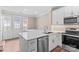 Modern kitchen with stainless steel appliances, white cabinets, and a stylish backsplash at 163 Singleton Rd, Mooresville, NC 28117