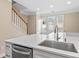 Bright kitchen area with stainless steel sink and ample counter space next to a stairway at 163 Singleton Rd, Mooresville, NC 28117