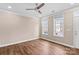 A bright living room features a ceiling fan and two windows with neighborhood views at 163 Singleton Rd, Mooresville, NC 28117