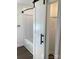 Bathroom with stylish barn door offering privacy to bathtub and open closet for storage solutions at 177 Valleydale Dr, Gastonia, NC 28056