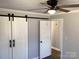 Spacious bedroom featuring modern ceiling fan, stylish barn doors and durable flooring at 177 Valleydale Dr, Gastonia, NC 28056