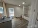 Bathroom with granite-style vanity, shower-tub combo, and durable laminate flooring at 188 13Th Se St, Hickory, NC 28602