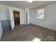 Bright bedroom featuring hard surface floors, closet, white doors and a window with blinds at 188 13Th Se St, Hickory, NC 28602