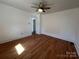 Bedroom with hardwood floors, white walls, and a ceiling fan with an open door frame at 188 13Th Se St, Hickory, NC 28602
