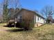 Rear exterior view with wooden deck and mature shrubbery, showcasing the home's curb appeal at 188 13Th Se St, Hickory, NC 28602
